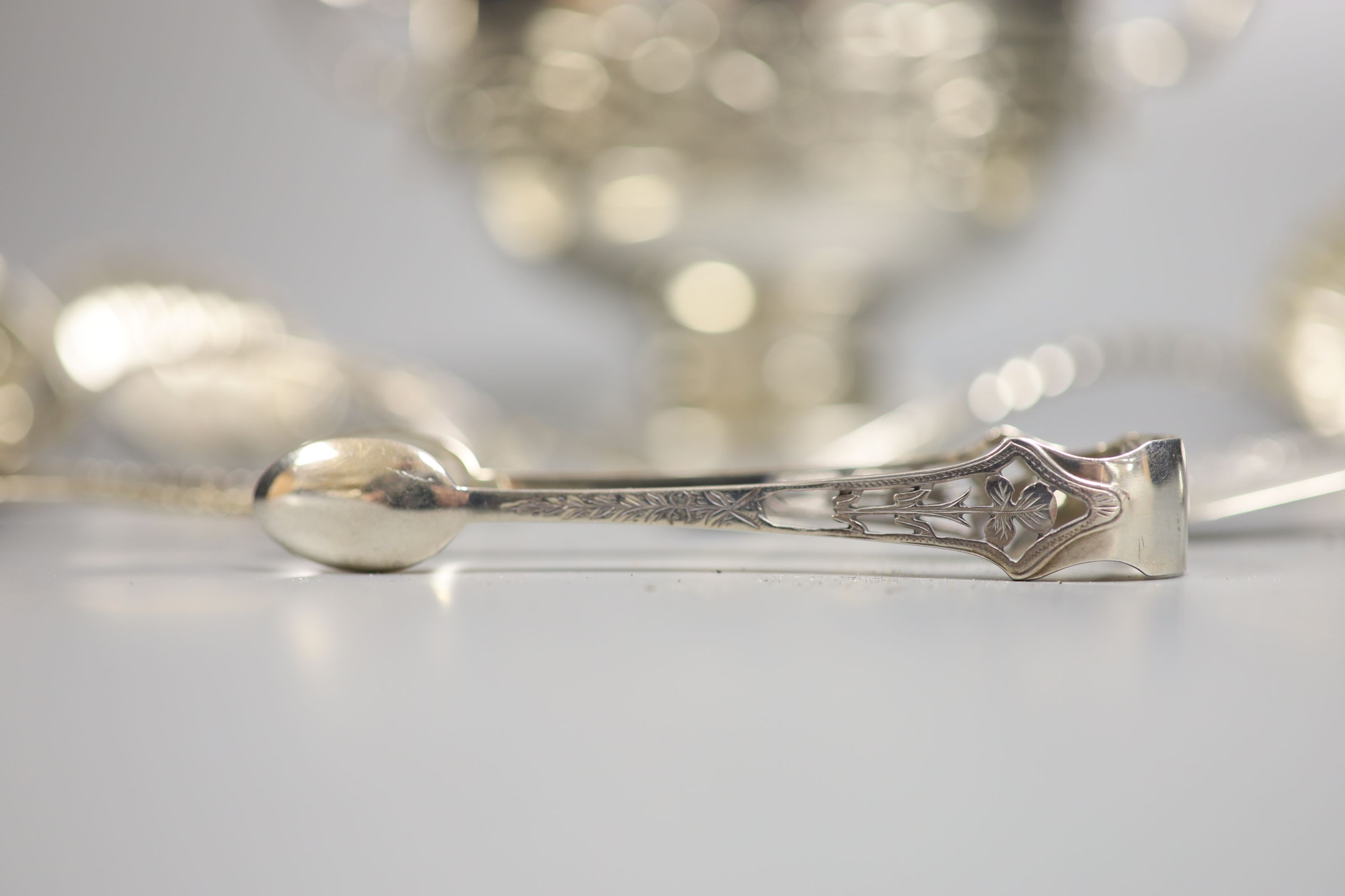 A George V silver Art Nouveau two handled bowl, Birmingham, 1912, height 11.3cm and seven items of silver flatware, 9.5oz.